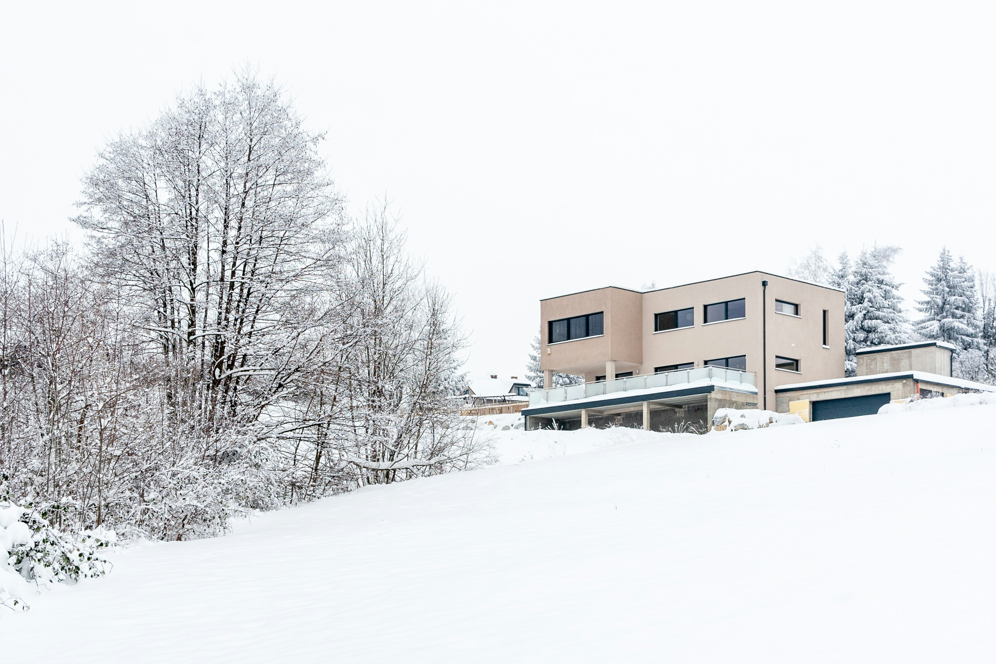 brown concrete building surrounded by snow covered ground during daytime